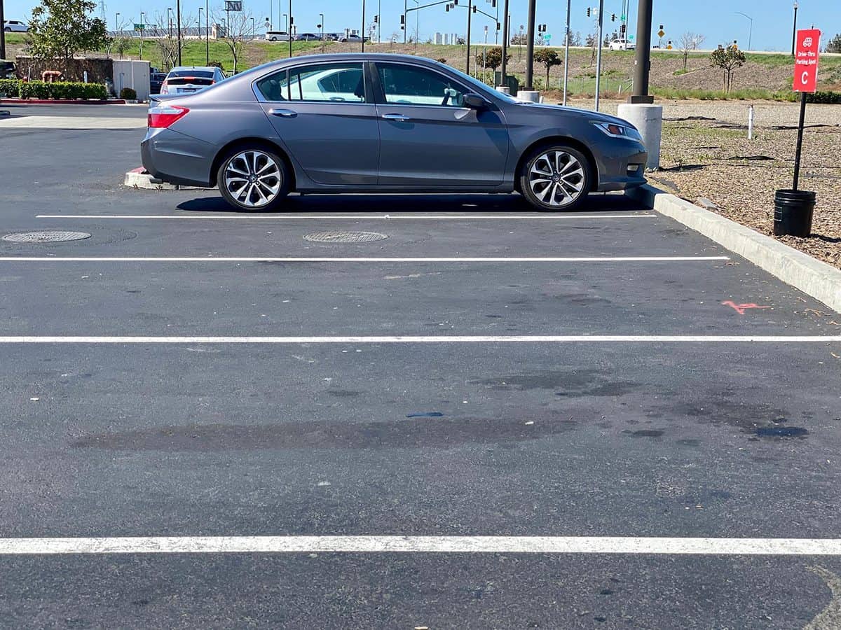 Honda Accord parked in a parking space with lots of empty spots