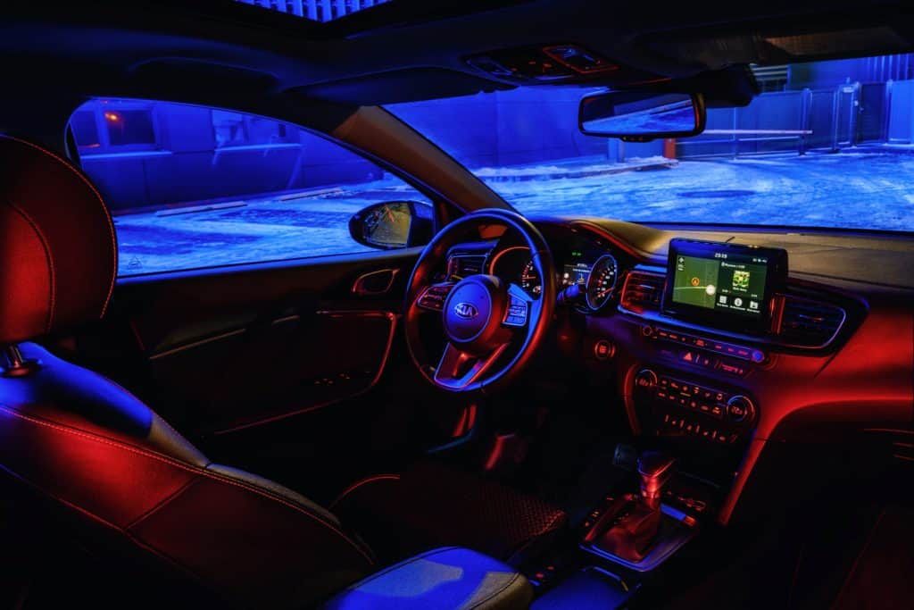 Interior of Kia Ceed 2018 car on in night city with neon color lights