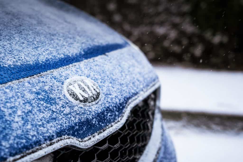 Kia logo in the bonnet of Kia car with snow in winter