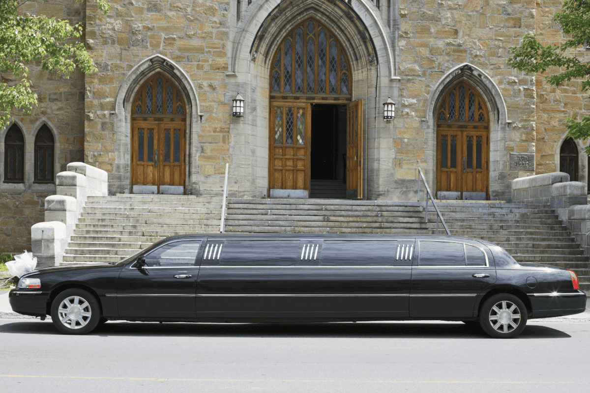 Luxury black limousine awaiting in front of a church