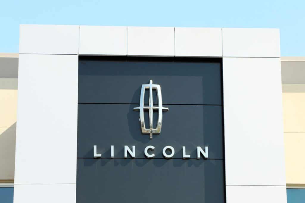 Sign and logo on the front of a dealership for Lincoln Motor Car Company, a division of the Ford Motor Company.