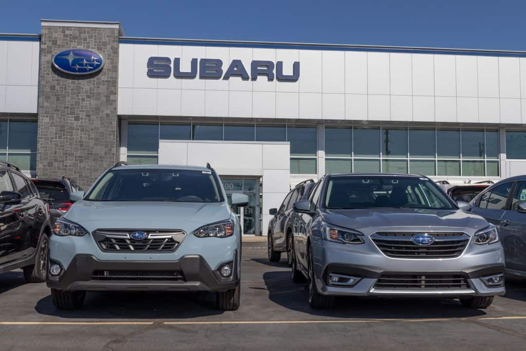 Subaru dealership with two different Subaru cars displayed in front
