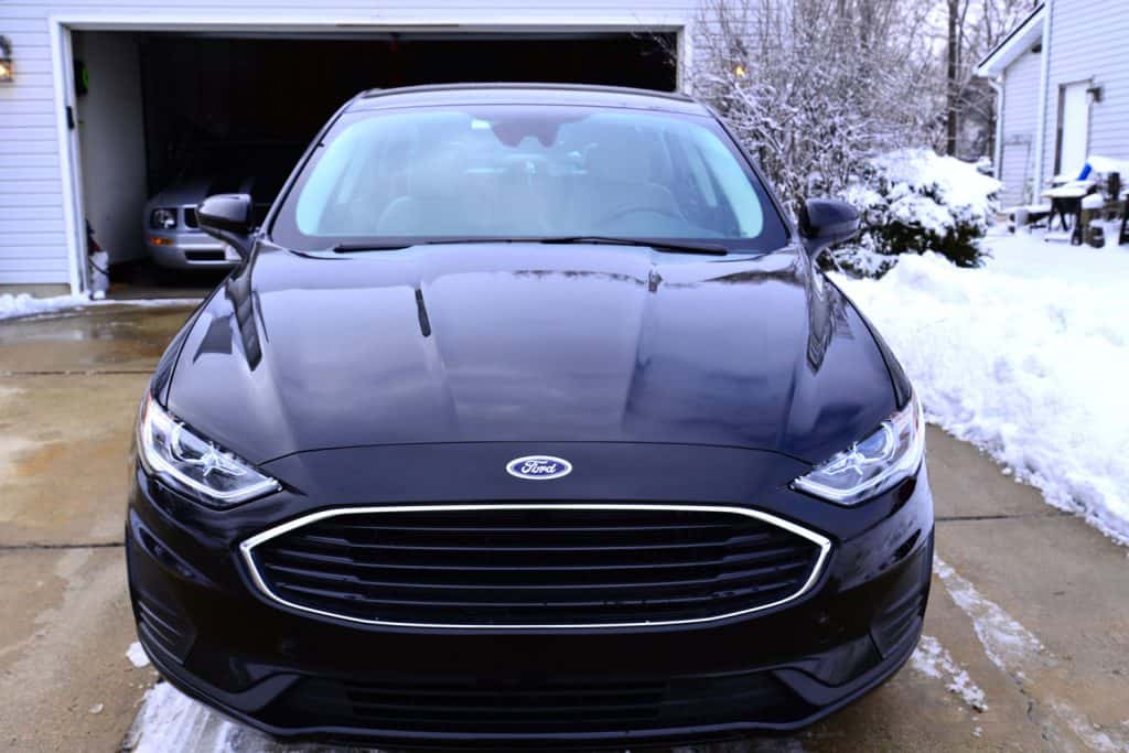  The front view of a shiny Agate Black 2020 Ford Fusion contrasted by freshly cleaned driveway after 4