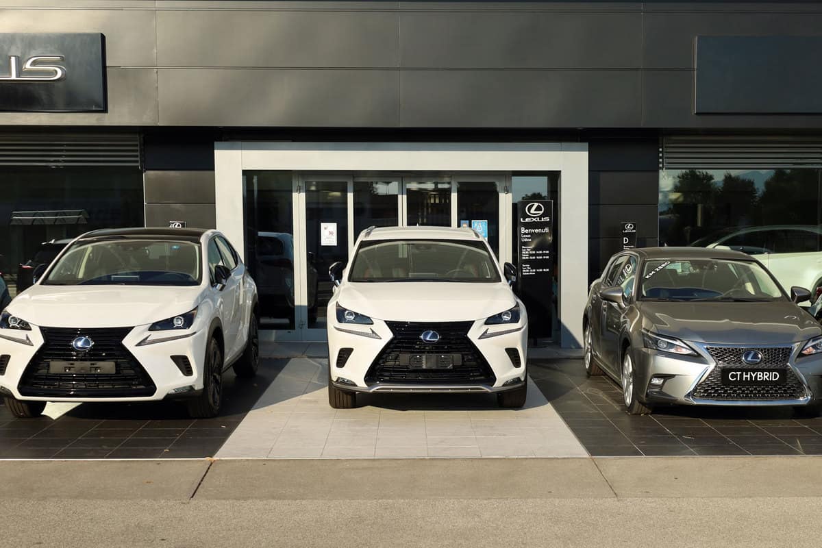 Three different trims of Lexus SUVs and sedans outside a dealership, Do Lexus Cars Require Premium Gas?