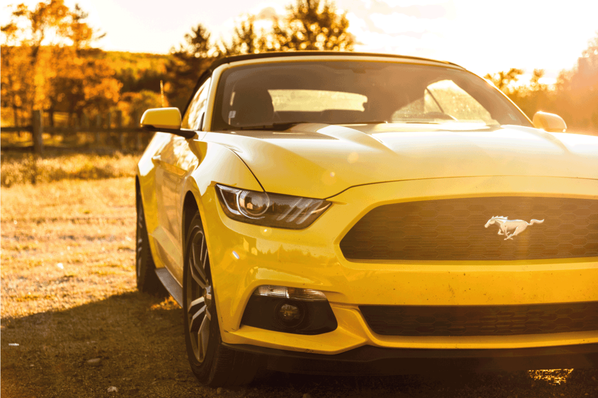 View of a yellow Ford Mustang GT convertible version parked on the countryside of Flagstaff in Maine at dusk