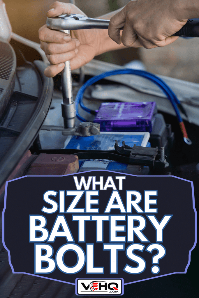The man tightens with a wrench bolts for fastening a new battery, What Size Are Battery Bolts?