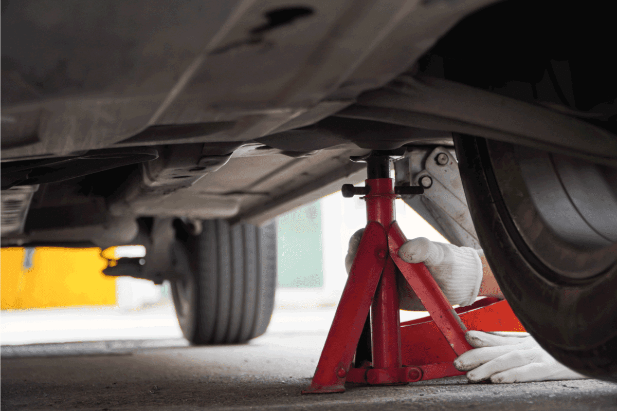 mechanic is using the jack to stand up safely in your car,Jack stands hold your vehicle up safely.