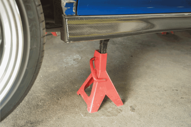 red-car-jack-stand-underneath-a-car-for-repair.-Does-Every-Car-Come-With-A-Jack