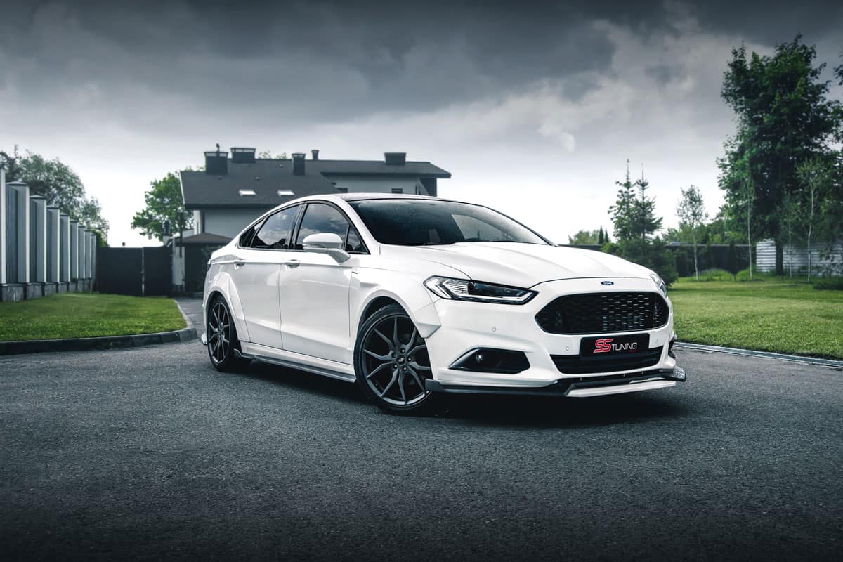 stunning glossy white metallic paint ford fusion on the middle of the road