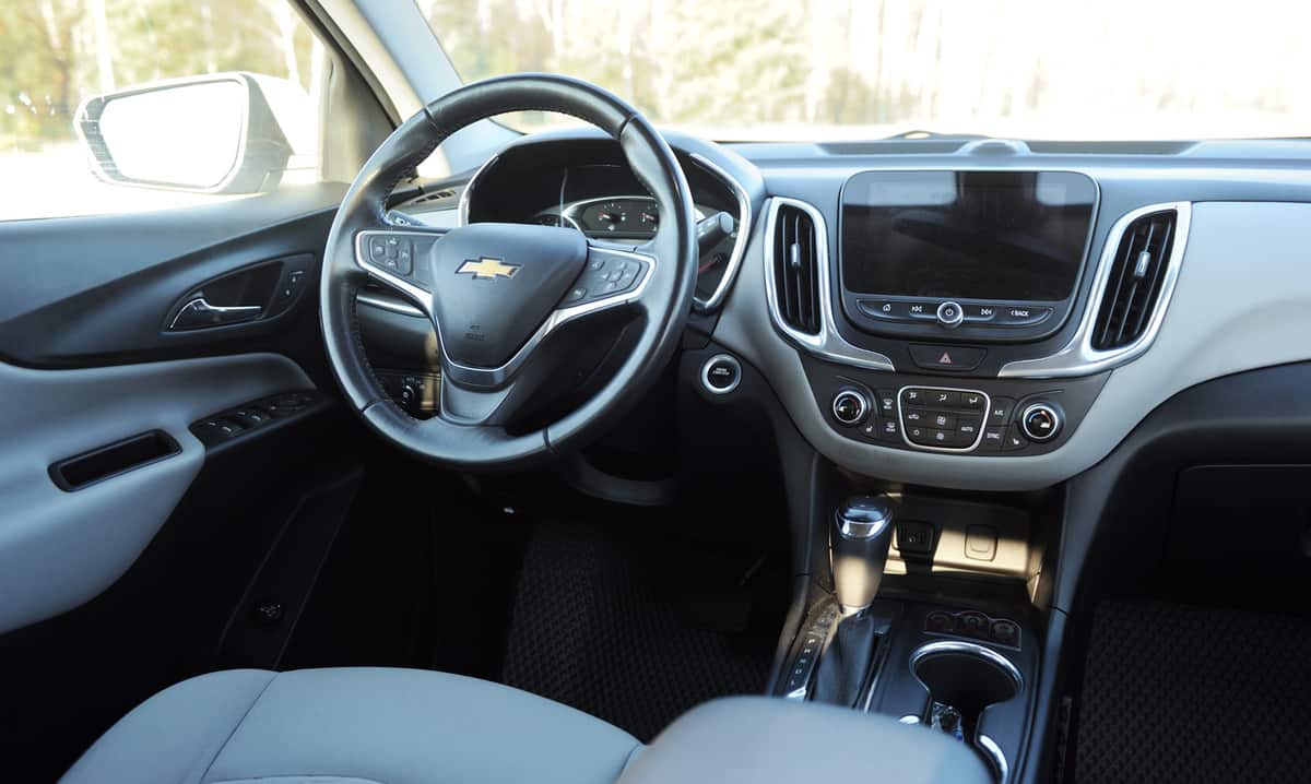 2017 Chevrolet Equinox SUV in white. Chevy, a division of General Motors, also makes Suburban, Cruze and Traverse. Car interior and dashboard.