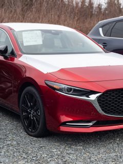 A red 2021 Mazda 3 at the dealership, Does Mazda 3 Have Blind Spot Monitoring? [By Year And Trim Level]