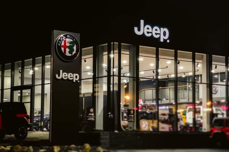 A Jeep dealership photographed at night, Do Jeep Dealerships Install Lift Kits? [And What Could It Cost?]
