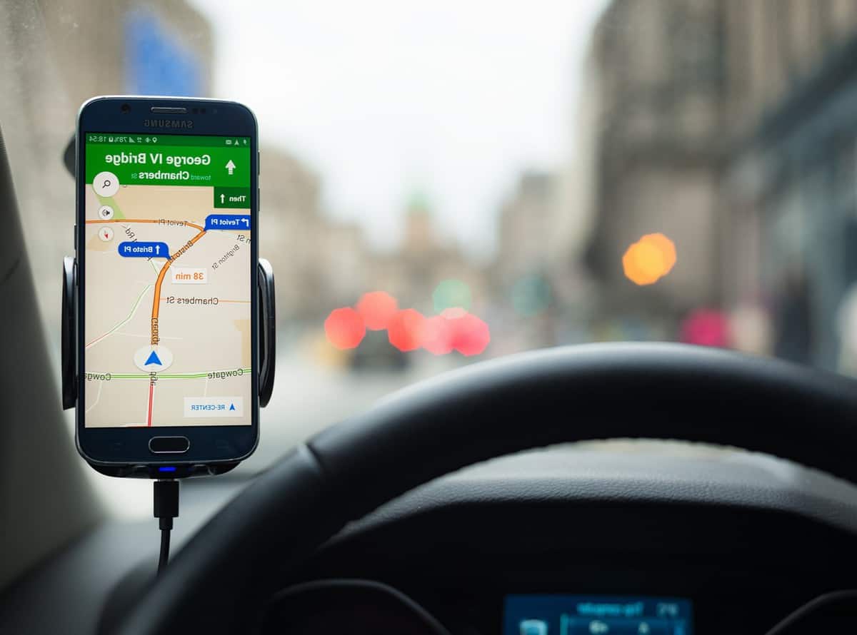 A Samsung S6 smartphone being used in a car, running Google's Maps navigation software for driving directions.