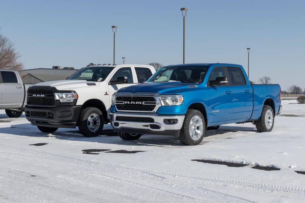 A blue and white colored RAM 1500 at a snowy parking lot