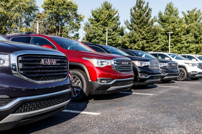 A line up of GMC Acadias and other GMC utility vehicles at a parking lot, How Long Does A GMC Acadia Last?