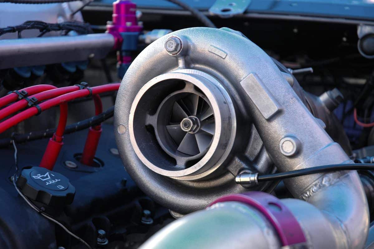 A massive turbocharger on the engine of a race car