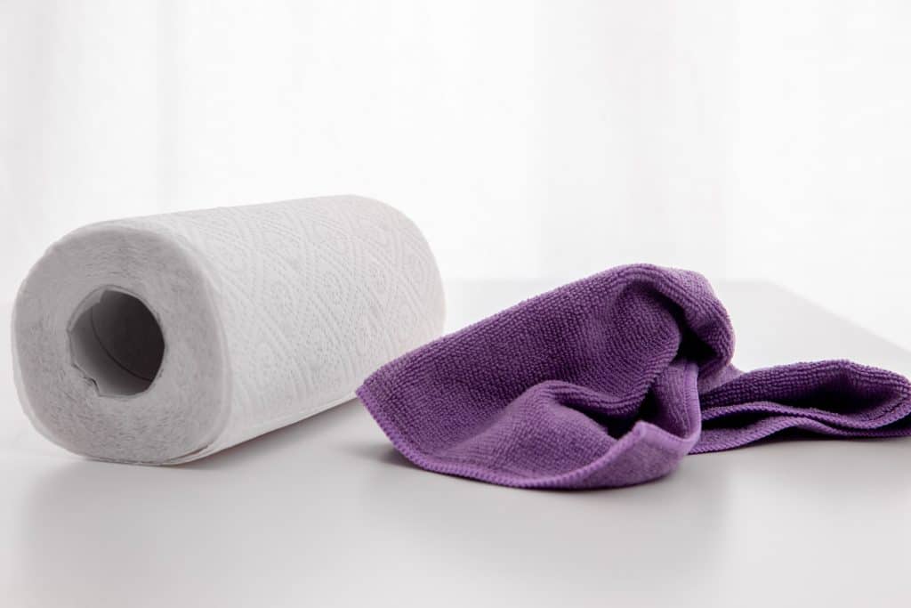 A paper towel and a purple cloth towel