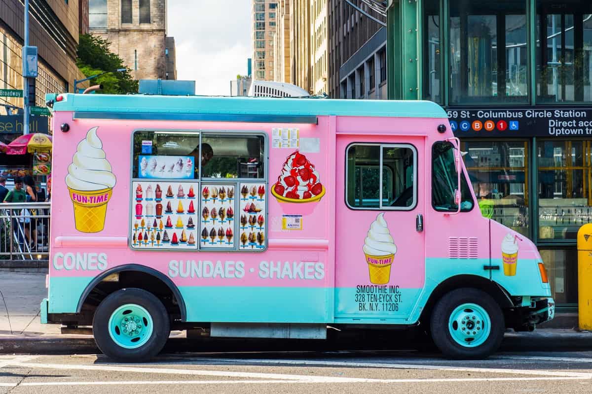 A pink ice cream truck on the streets of New York City