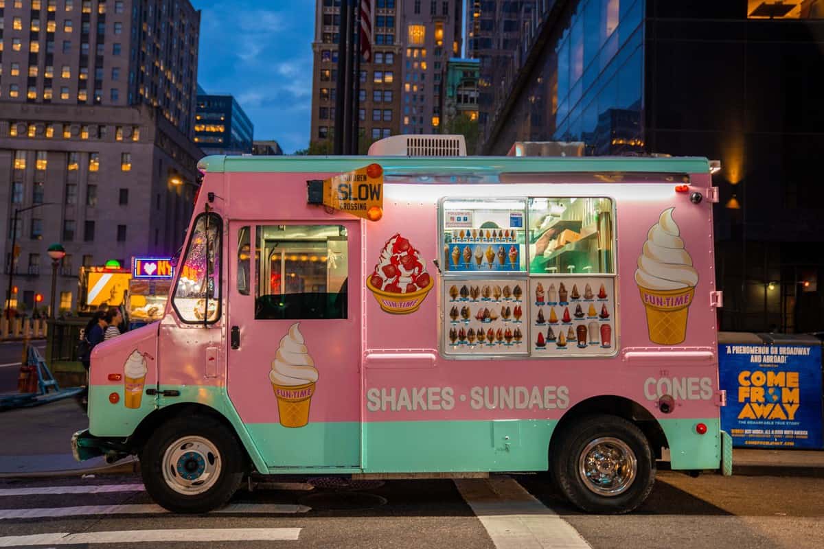 A pink ice cream truck on the streets of New York City