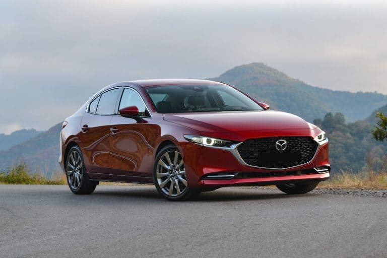A red colored Mazda 3 parked on the side of the highway, What Are The Best Tires For Mazda 3