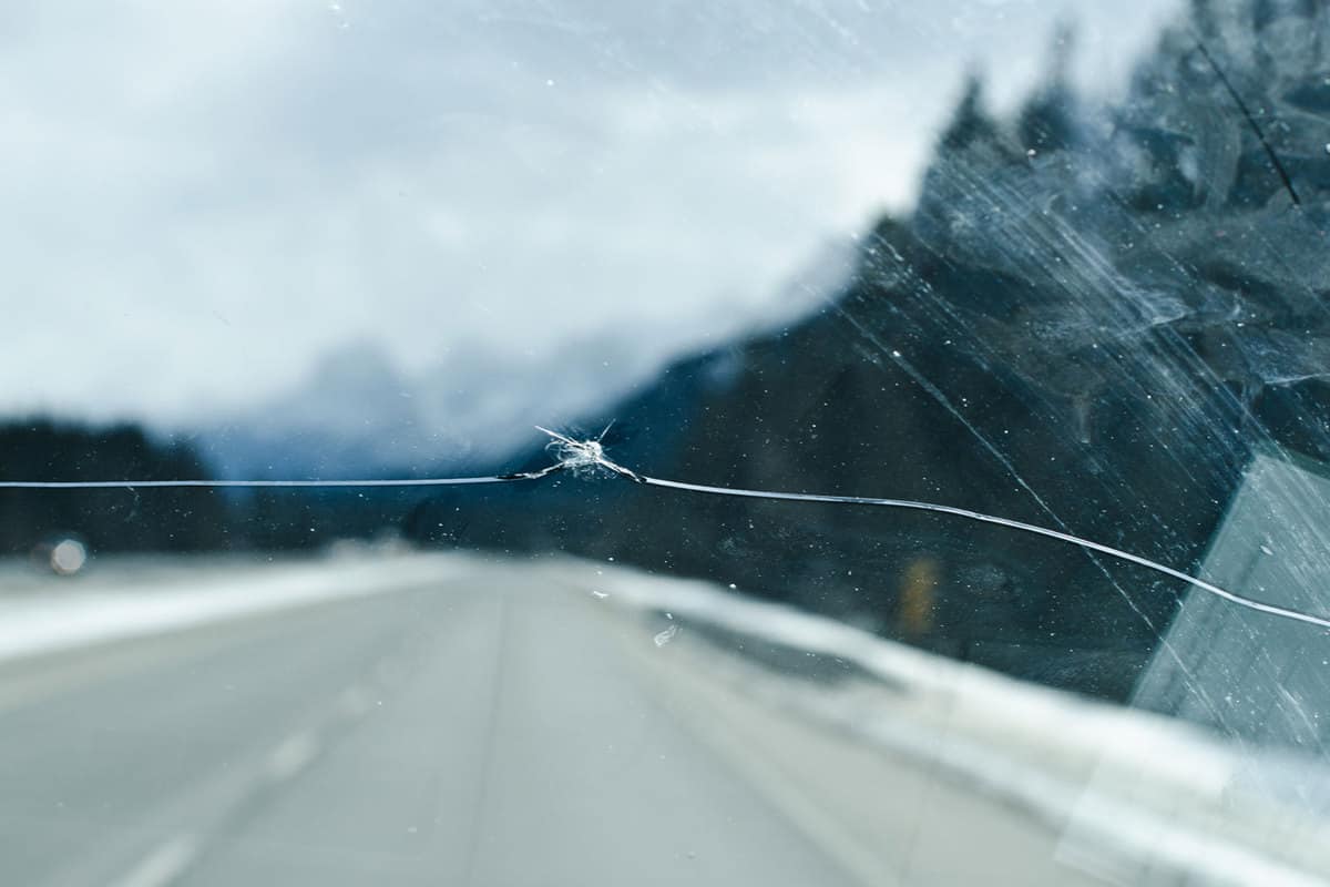 A small crack running throughout the windshield of the car
