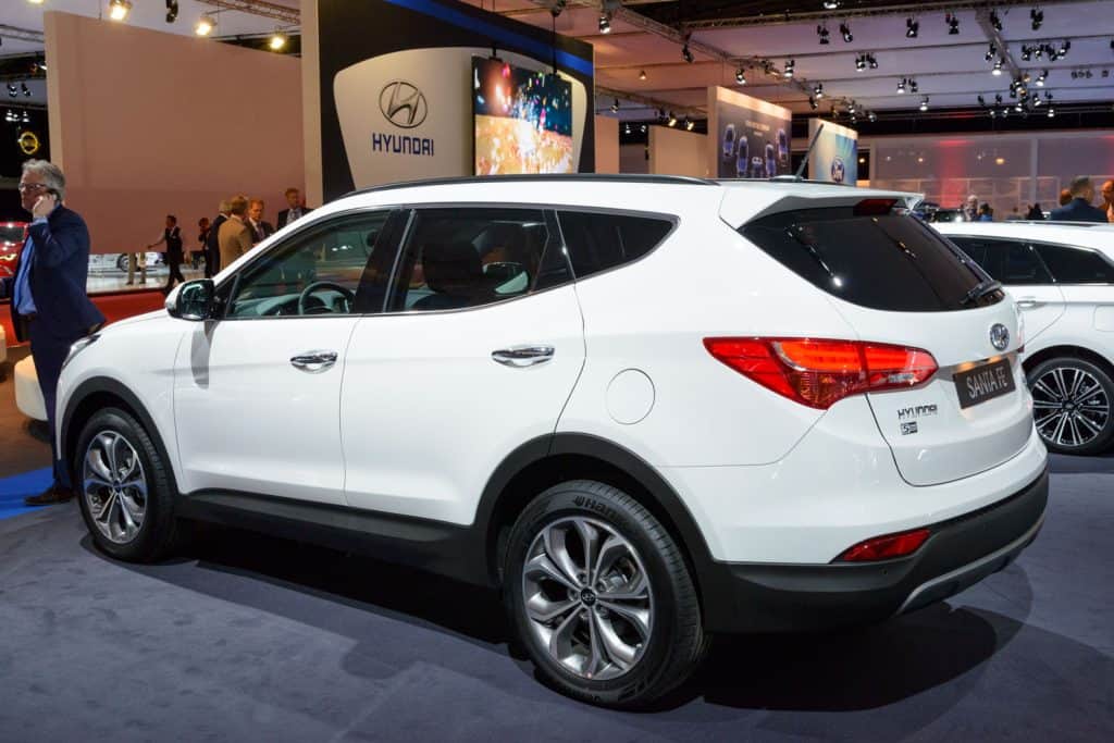 A white Hyundai Santa Fe at a car show