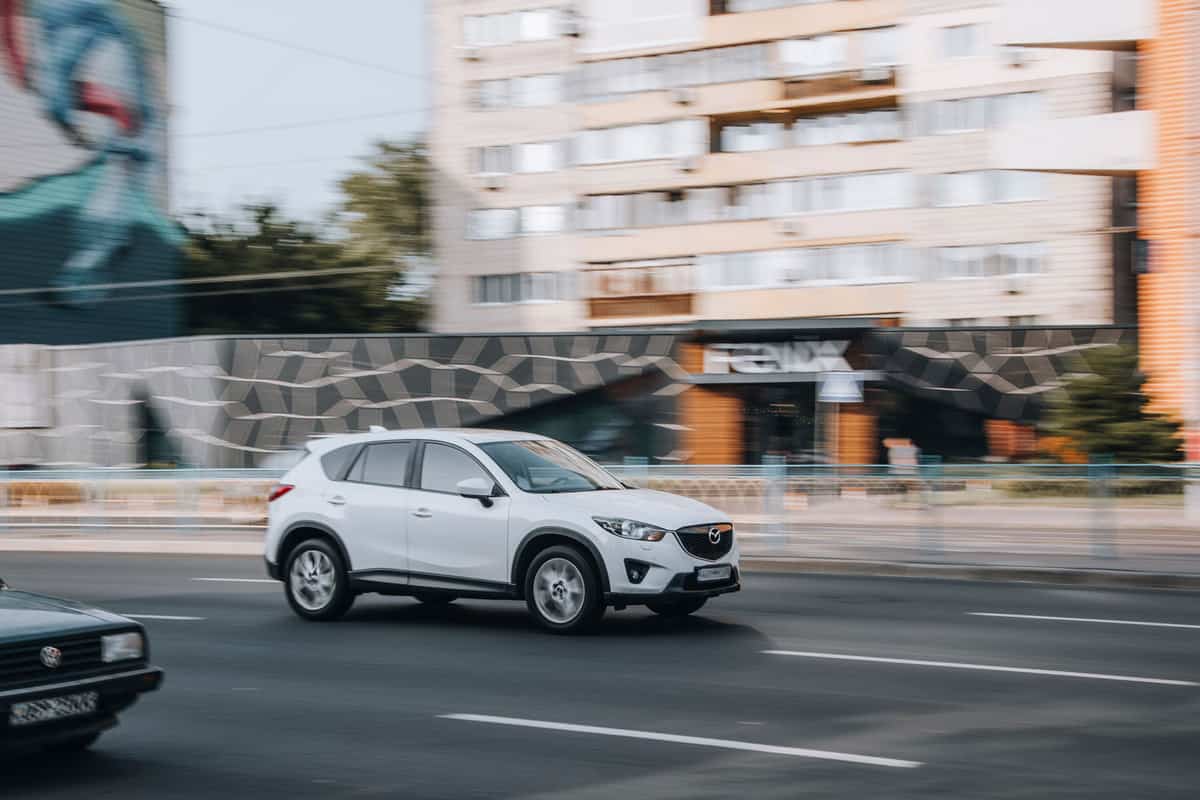 A white Mazda CX-5 photographed on the highway