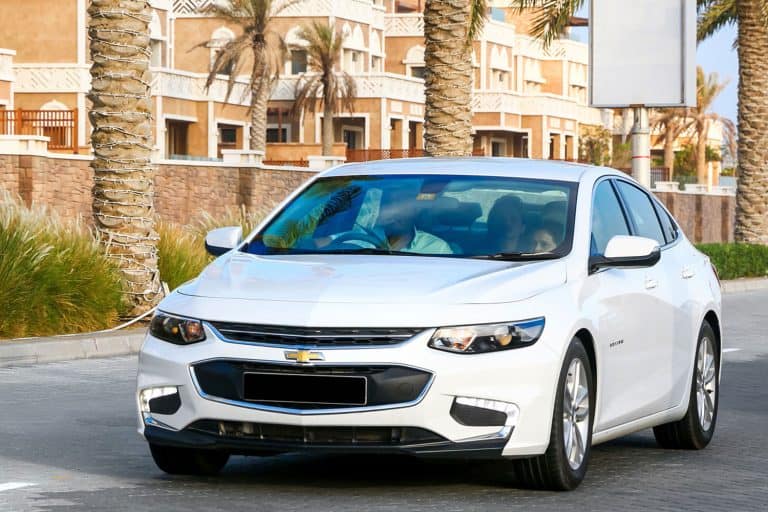 A white colored Chevy Malibu at the highway, Chevy Malibu Saying Shift To Park—What's Wrong?