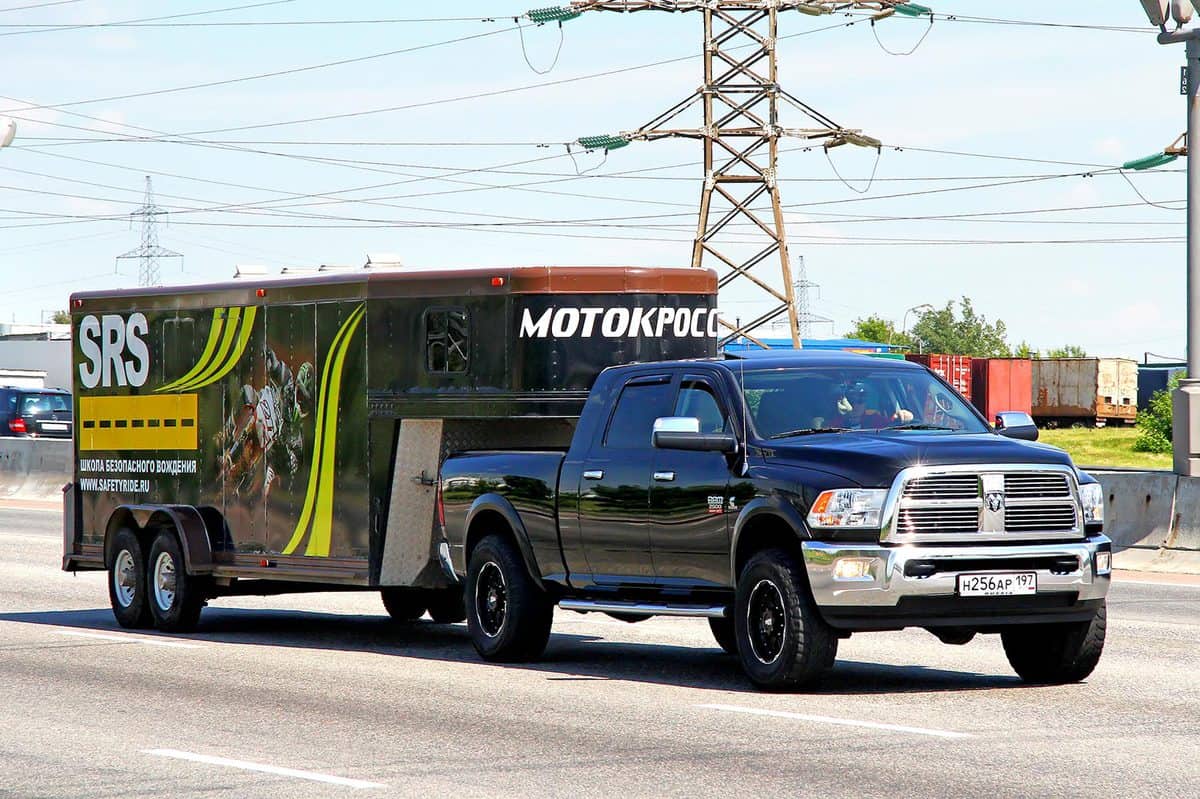 American pickup truck Dodge Ram 2500 of the motocross racing team drives at the interurban road