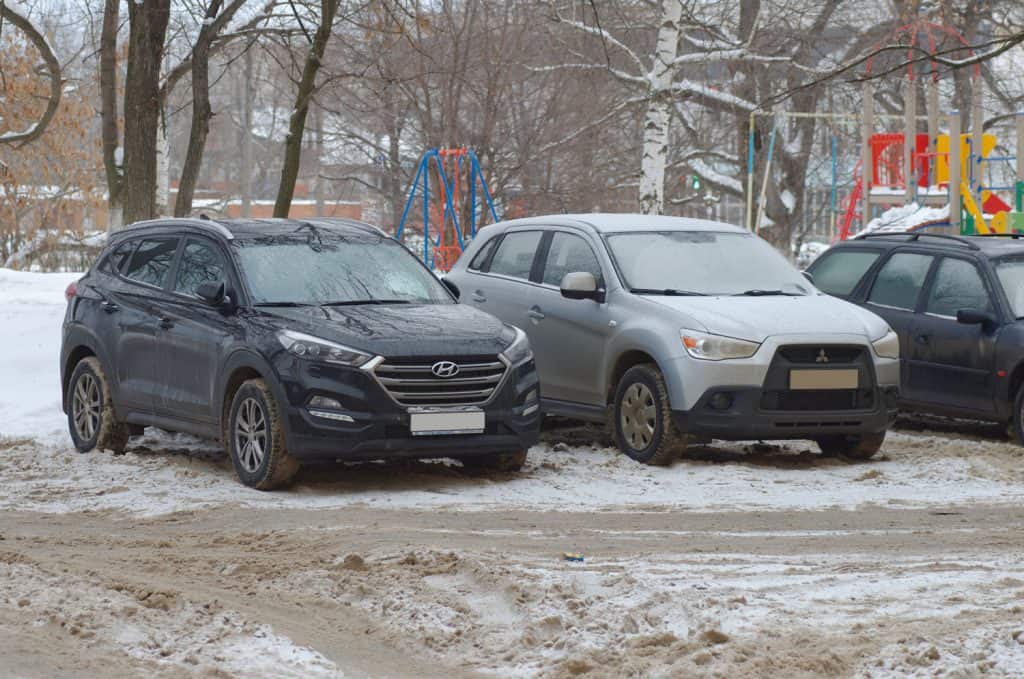 Black Hyundai Tucson and silver Mitsubishi ASX on parking lot