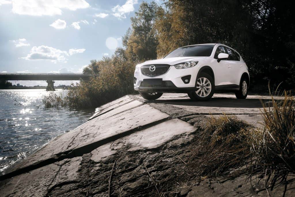  Car Mazda CX-5 stand on asphalt countryside road near river at daytime