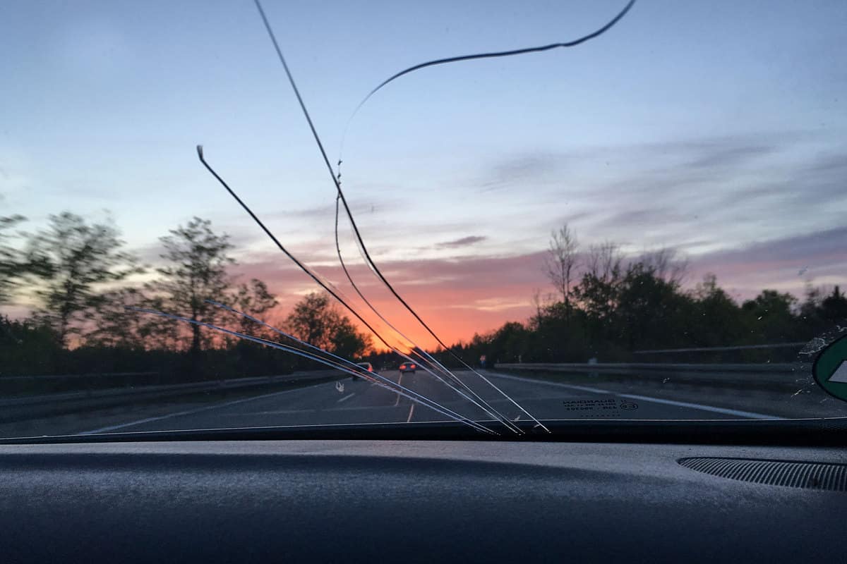Car moving on the highway with a cracked windshield