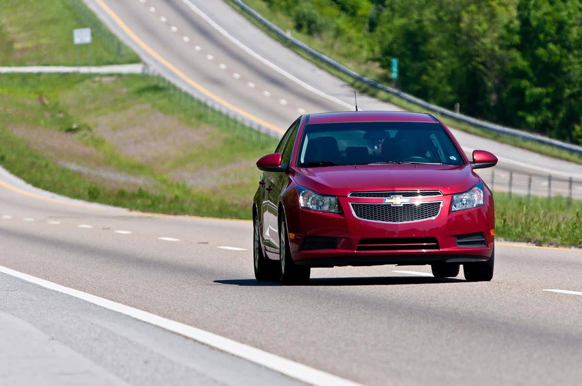 Chevrolet Malibu changes lanes on interstate highway