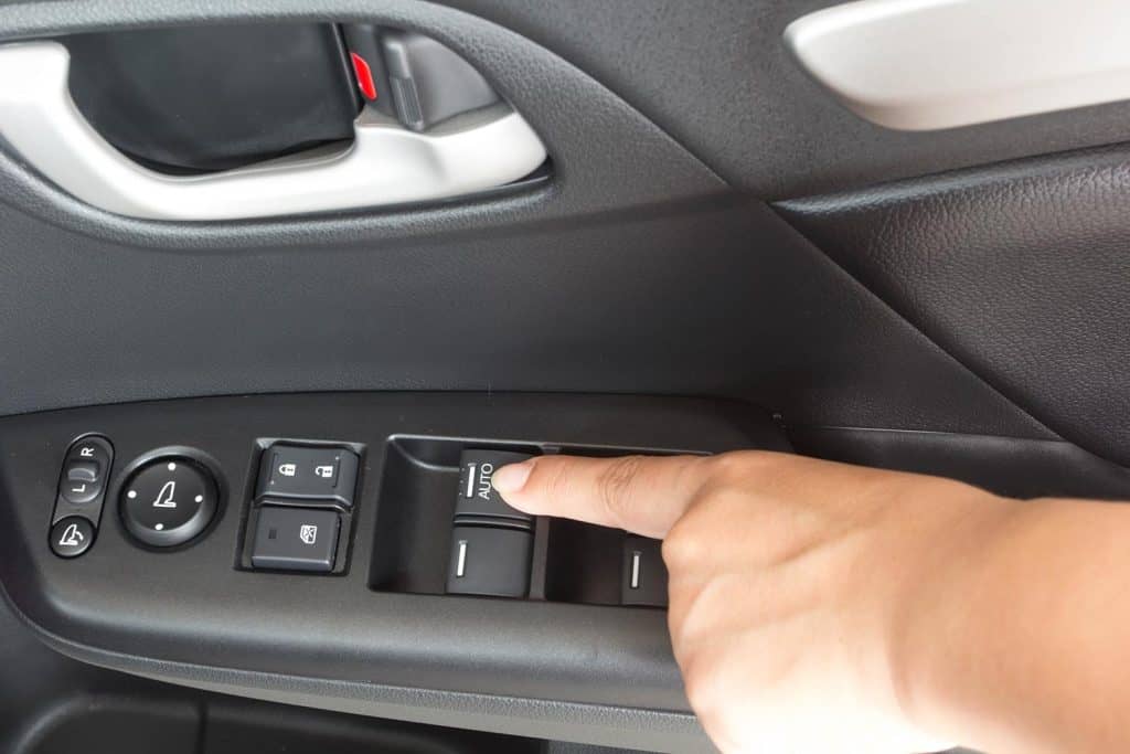 Driver's hand pressingcar window controls button