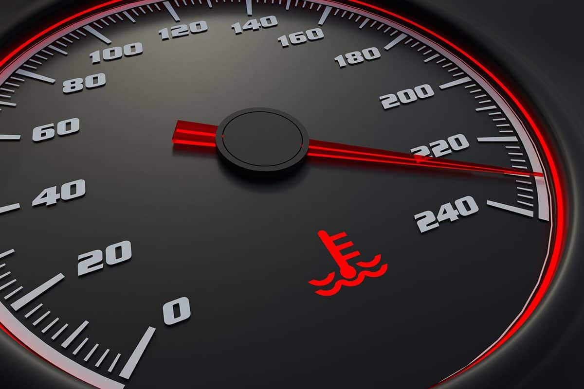 Engine temperature warning light on car dashboard
