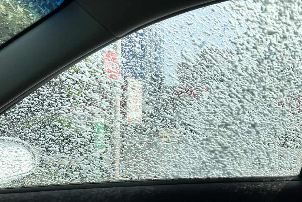 Foam on the window for car cleaning