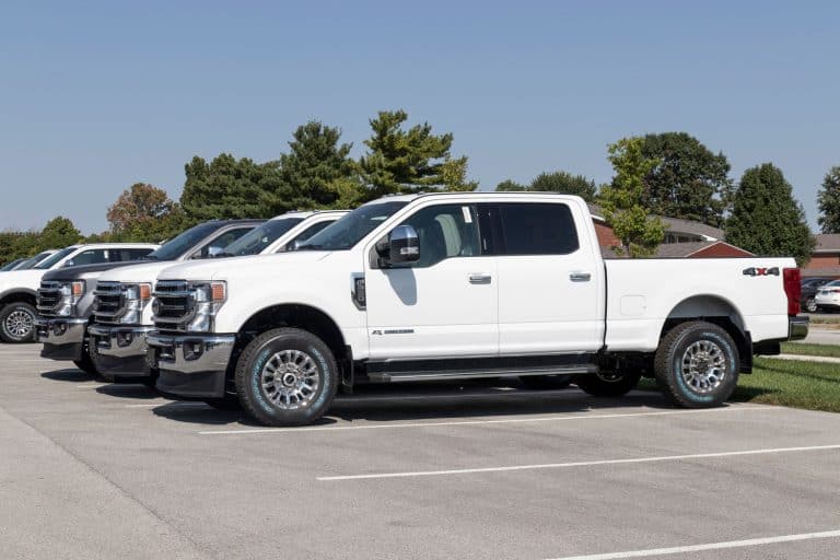 Ford F-250 display at a dealership. The Ford F250 is available in XL, XLT, Lariat, King Ranch, and Platinum models, Ford F250 Limited Vs. Platinum - Which Is Right For You?