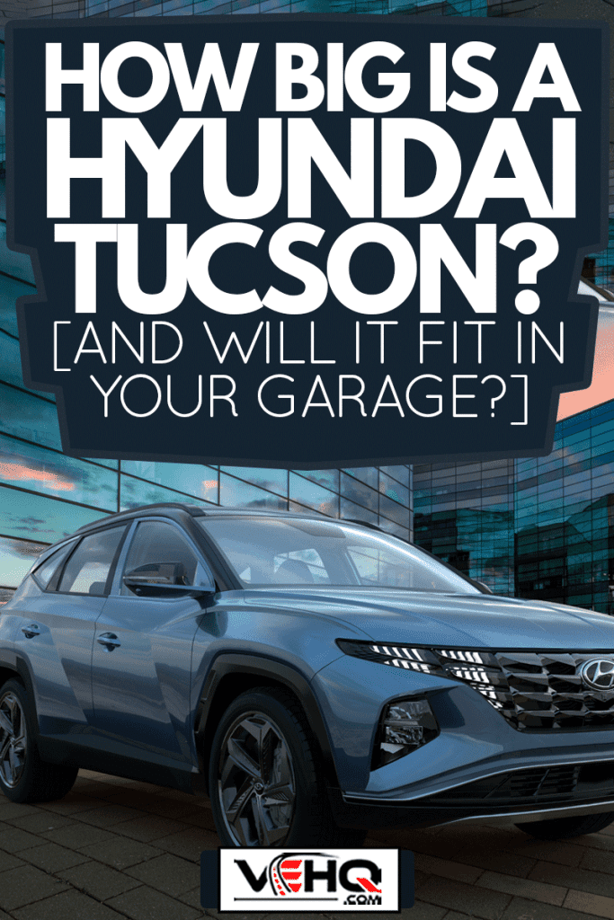 Hyundai Tucson in the parking lot in front of a modern office building, How Big Is A Hyundai Tucson? [And Will It Fit In Your Garage?]