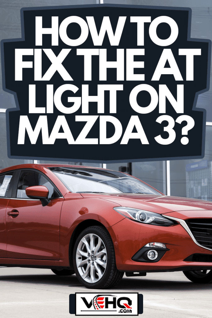 A new Mazda 3 GT hatchback vehicle on a car dealership lot displayed in front of the showroom, How To Fix The AT Light On Mazda 3?
