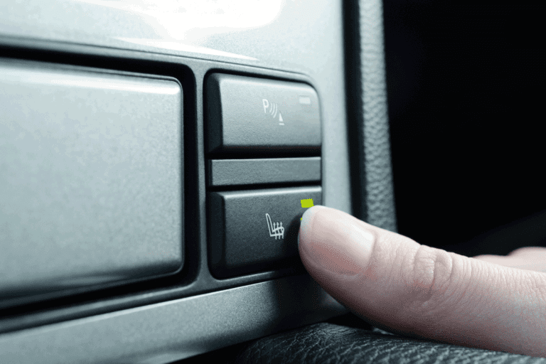 Man pressing the heating seat button in the car. Does The Lexus NX Have Heated Seats