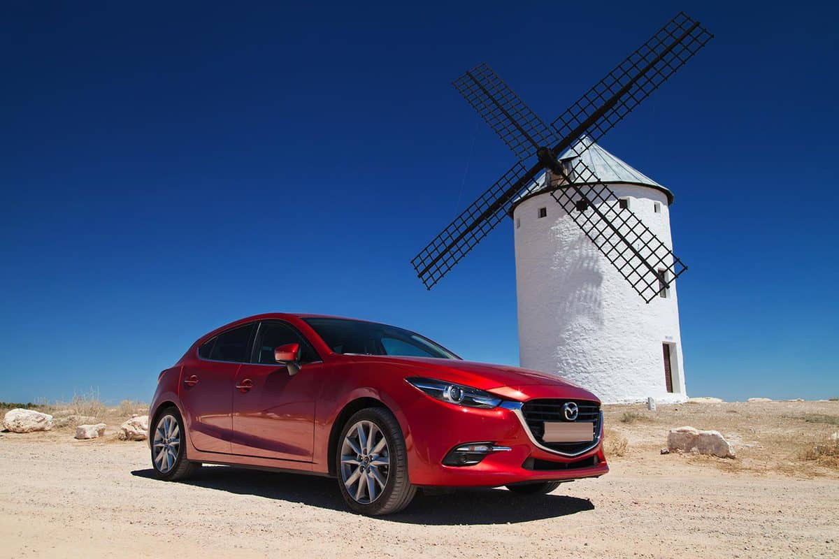 Mazda 3 Hatchback in front of a traditional windmill
