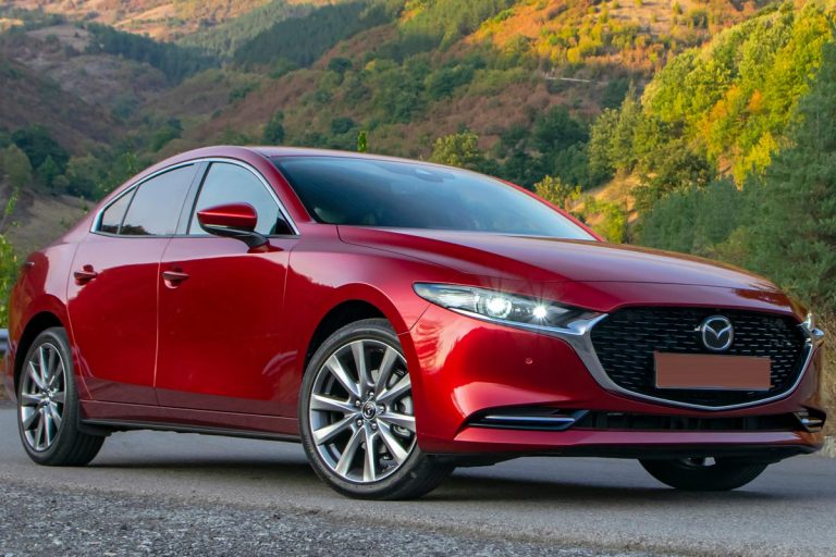 A Mazda3 Sedan stopped on a mountain road, Does Mazda 3 Have A Remote Start? [And How To Use It]