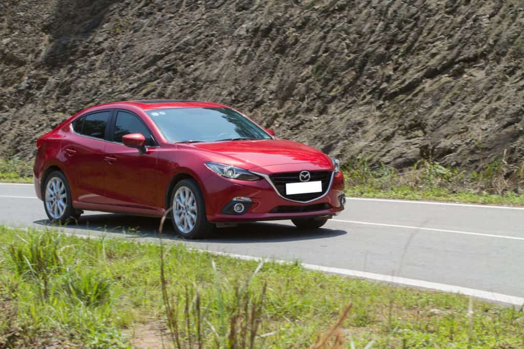 Mazda3 all new (2015) car running on the moutain road