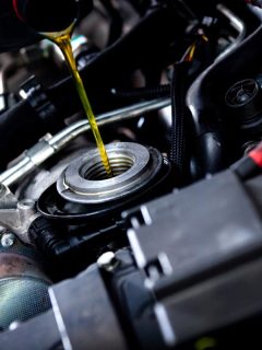 A mechanic adding oil to a car engine, What's The Best Type Of Oil For A Hyundai Sonata?