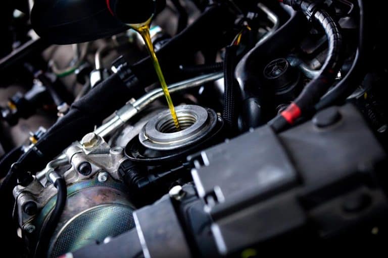 A mechanic adding oil to a car engine, What's The Best Type Of Oil For A Hyundai Sonata?