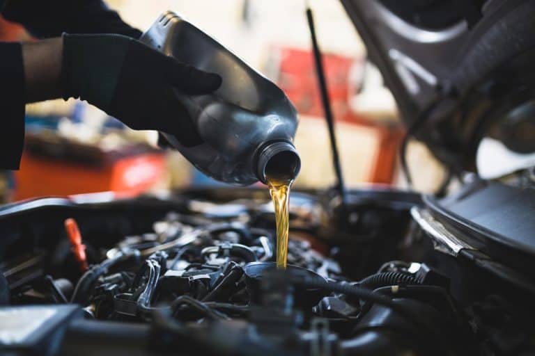 A mechanic doing car service and maintenance, What Engine Oil is Best for Hyundai Tucson?