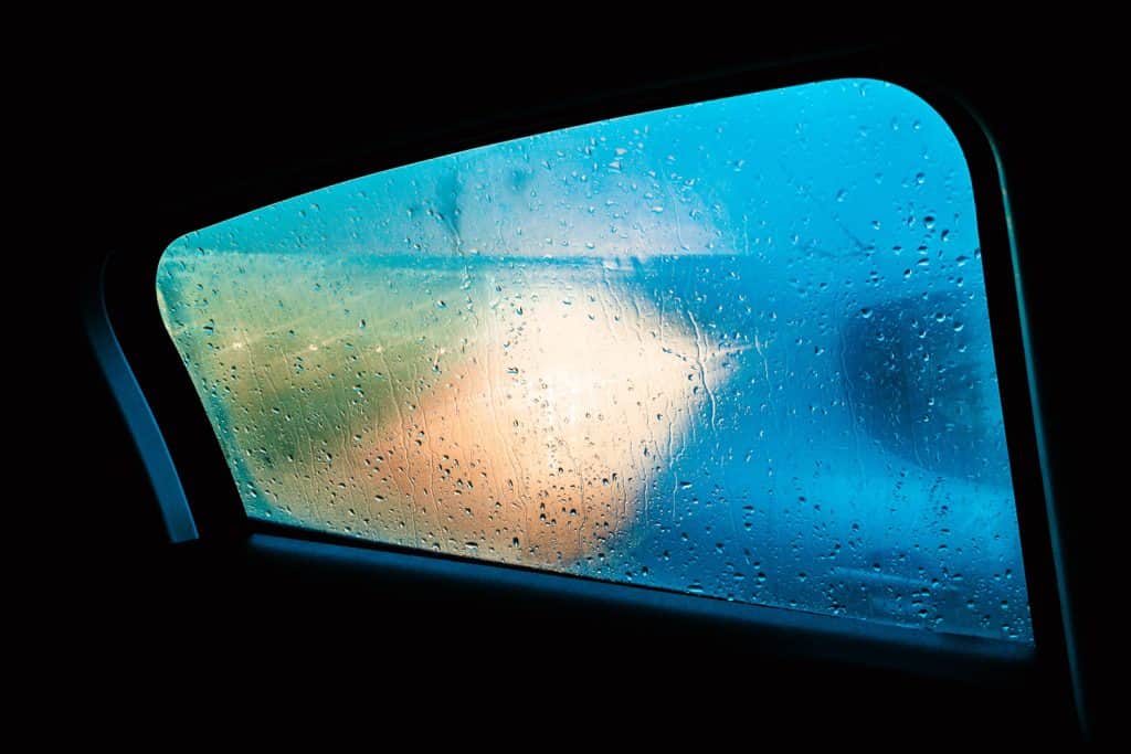 Moist and water on the passenger window due to heavy rain