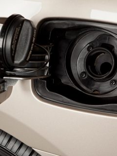 An open gas tank of a white car, How To Open The Gas Tank On A Chevy Malibu