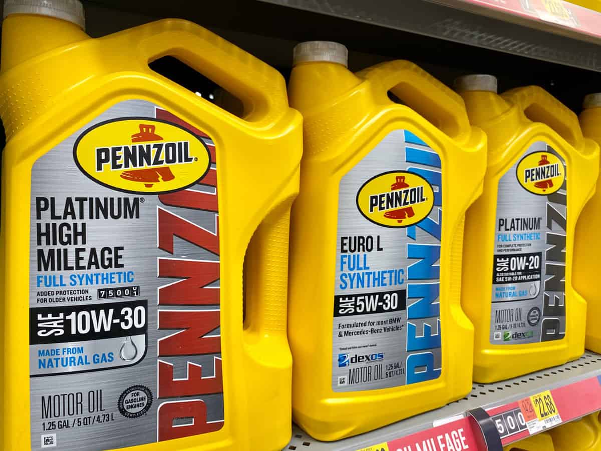 Pennzoil Platinum High Mileage 5 quart oil containers inside car maintenance department of Walmart.
