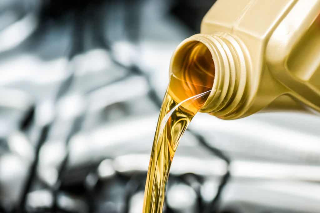 Pouring synthetic oil to the car engine